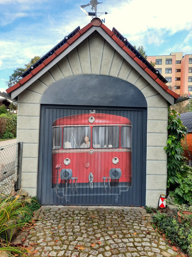 Illusionen auf ein Garagentor malen: der Schinenbus kommt aus dem Tunnel